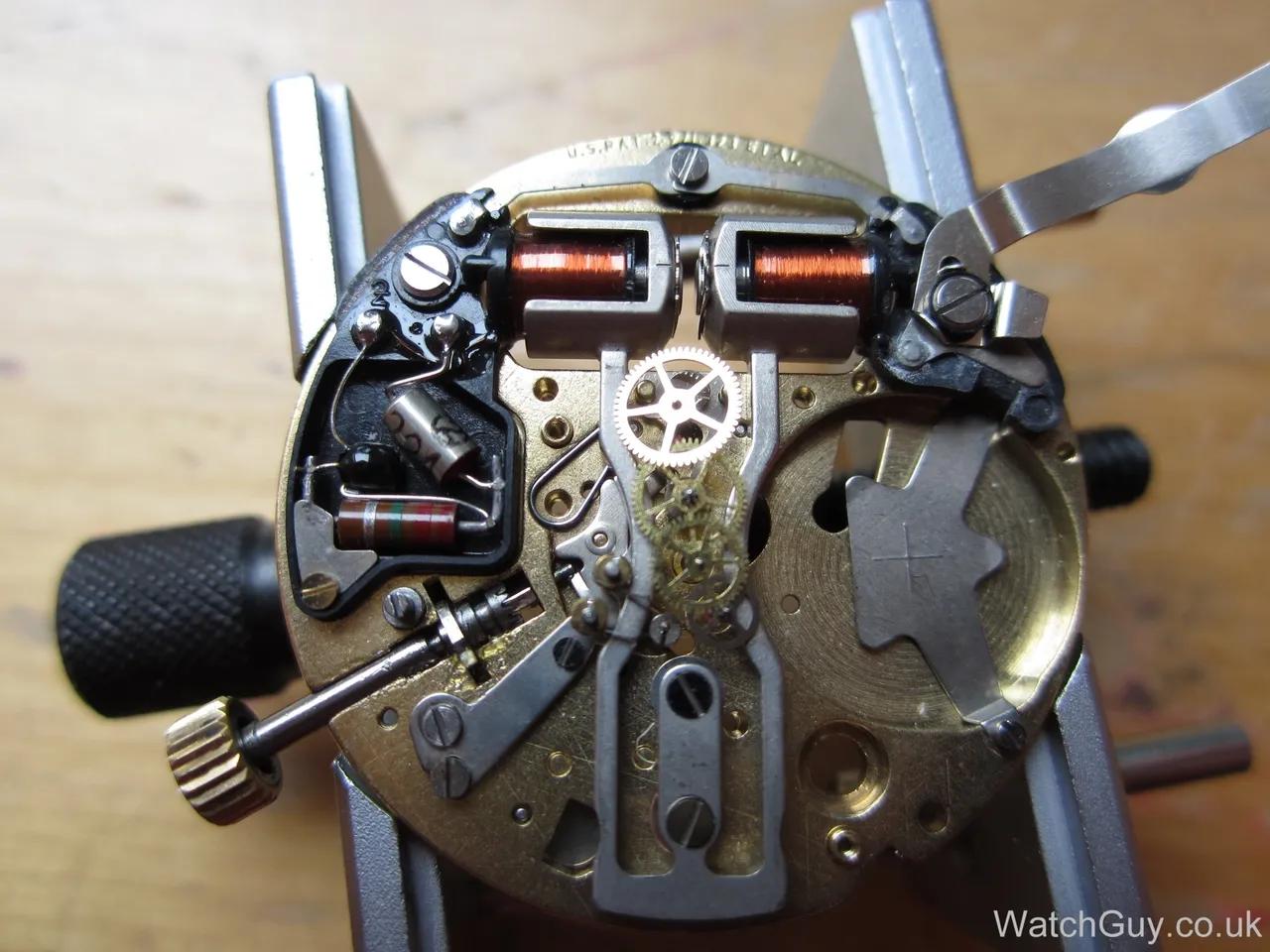 Close-up of a disassembled watch mechanism.