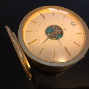 A clock is sitting on the table with its hands