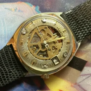 A watch with a gold face and black strap.