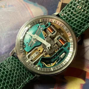 A watch with some parts missing on top of a map.