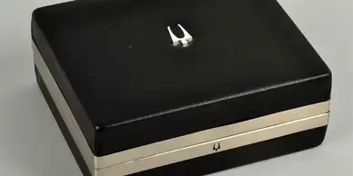 A black box with two white handles on top of it.
