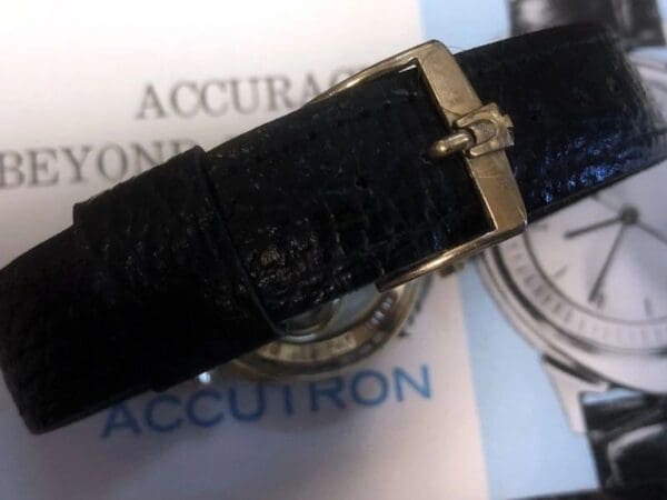 A close up of the strap on an accutron watch