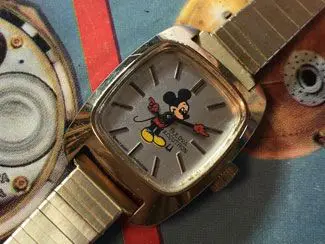 A watch with mickey mouse on the face of it.