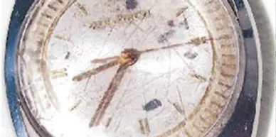 A close up of the clock face on a floor