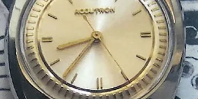A close up of the face of an analog watch