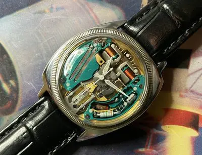 A watch with some parts missing on the side of it