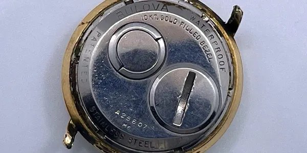 A close up of the back side of a watch