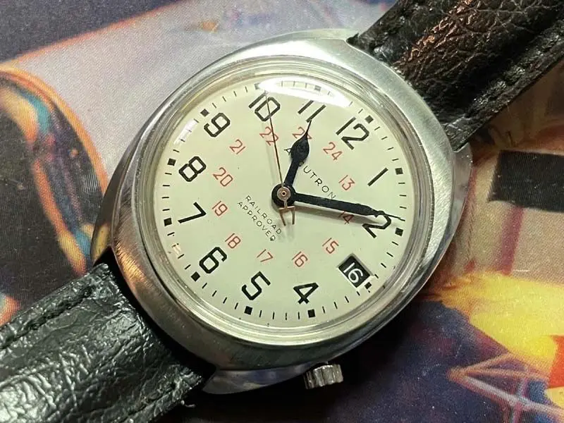 A watch is shown on top of some papers.