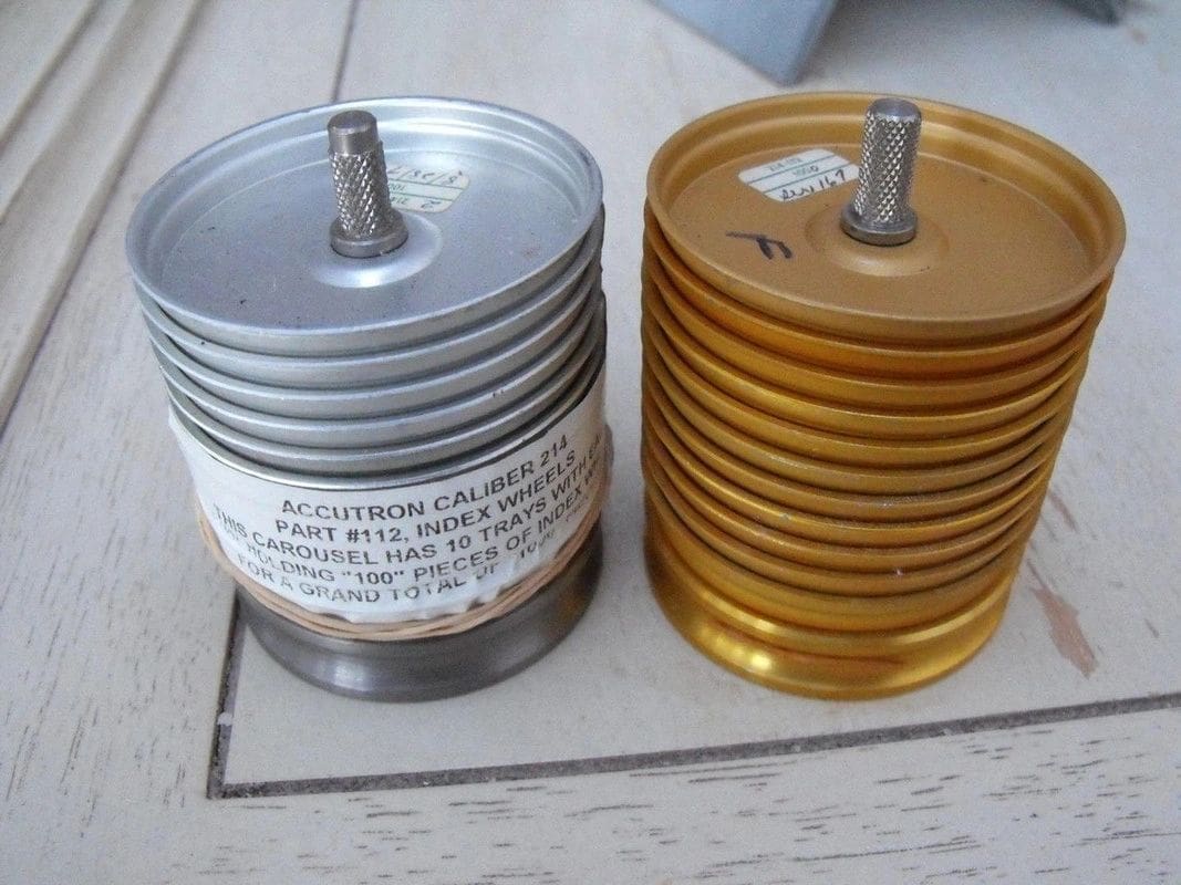 Two cans of electrical wire are next to each other.