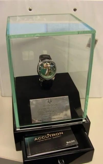 Accutron watch in glass display case.