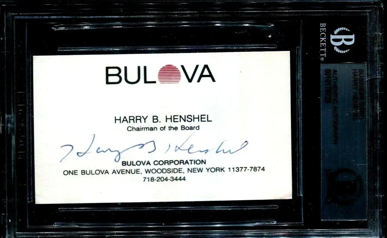 Bulova Corporation business card with signature.