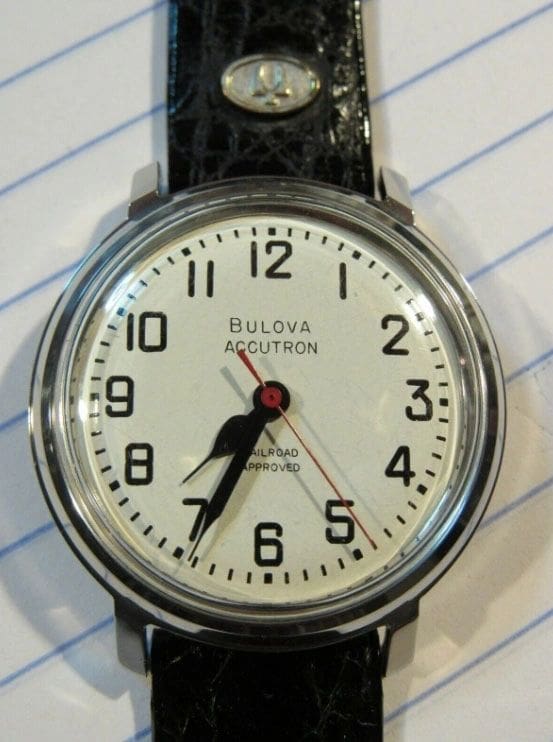 Bulova Accutron wristwatch with black band.