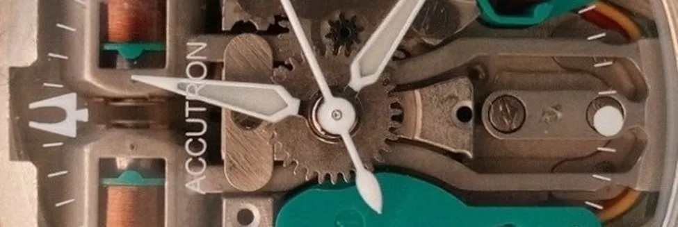 Close-up of watch mechanism and Accutron logo.