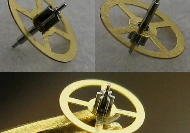 Gold watch gear with spokes and a pin.