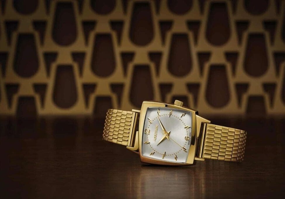 Gold Accutron watch with square face.