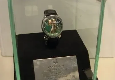 Accutron watch in glass display case.