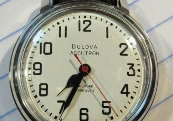 Bulova Accutron wristwatch with black band.