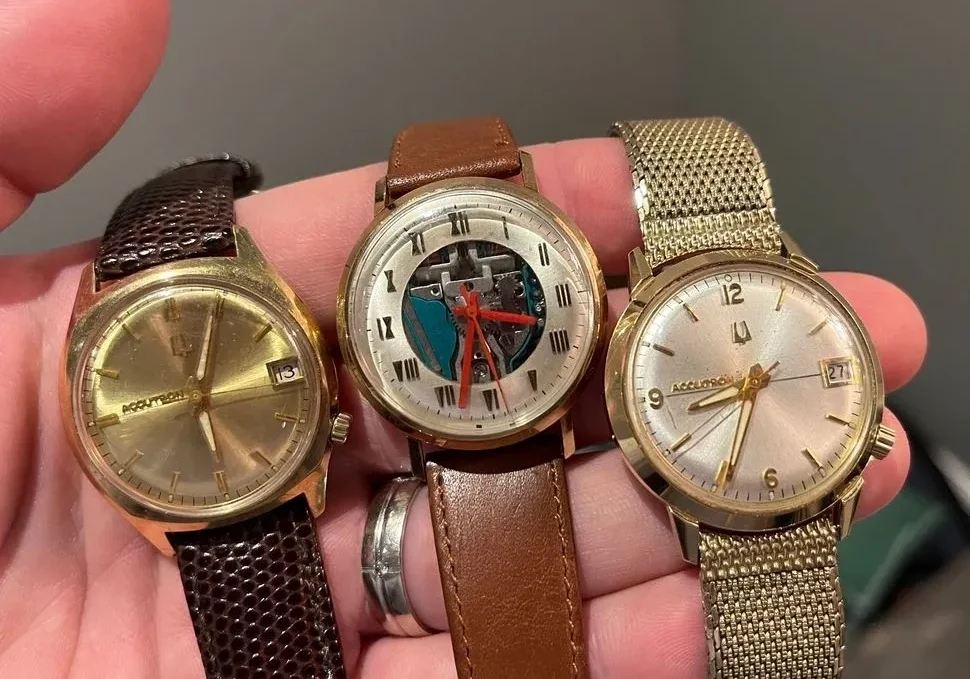 Three gold Accutron wristwatches on a hand.