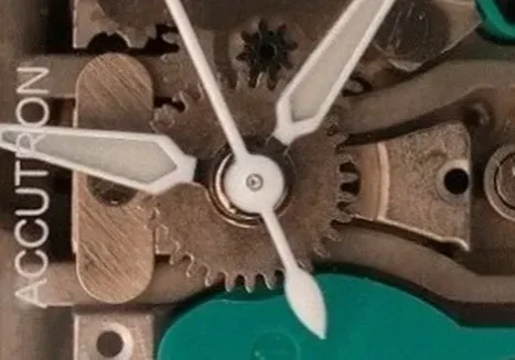 Close-up of watch mechanism and Accutron logo.